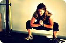 Stretching before a hefty set of front squats during a foundation workout. (Photo by Mei Ratz)